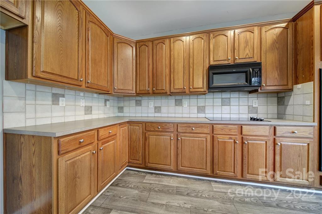 1704 Quartz Lane Fort Mill, SC 29708 - Photo 7 of 39 a kitchen with stainless steel appliances granite countertop a sink a stove and a microwave