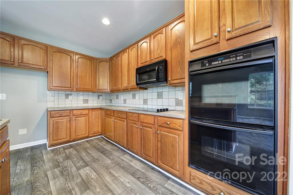 1704 Quartz Lane Fort Mill, SC 29708 - Photo 8 of 39 a kitchen with granite countertop wooden cabinets stainless steel appliances and a sink
