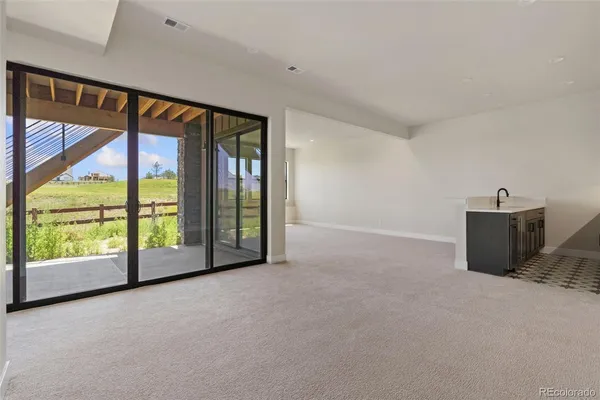 a view of an empty room with windows and view