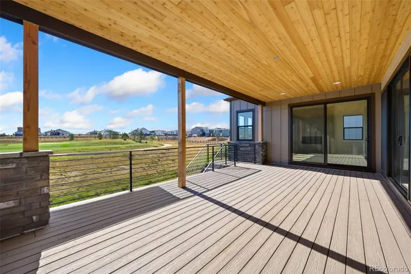 a view of balcony with floor to ceiling windows with wooden floor