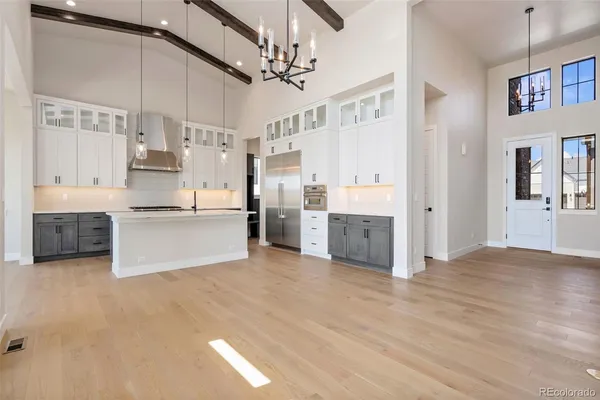 a view of kitchen with stainless steel appliances cabinets and a ceiling fan