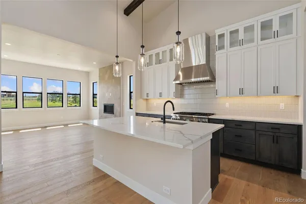 a kitchen with stainless steel appliances granite countertop a sink and a stove