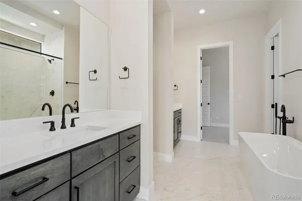 a en suite bathroom with a double vanity sink a mirror and a shower