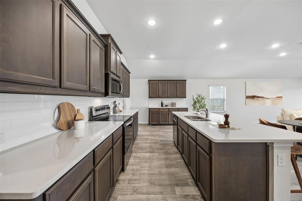 3807 Dogwood Road Melissa, TX 75454 - Photo 5 of 38 a kitchen with a sink stove and cabinets