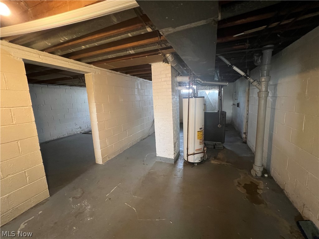 20731 Donnybrook Road Maple Heights, OH 44137 - Photo 12 of 17 Basement featuring gas water heater, heating unit, and brick wall