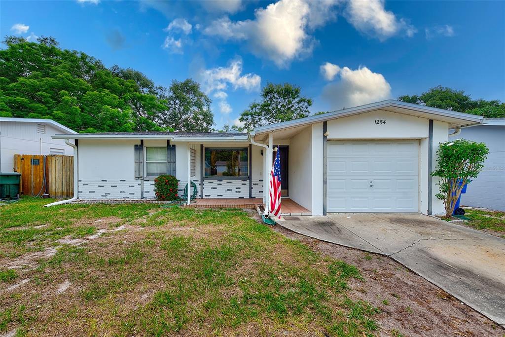 1254 8th Avenue Northeast Largo, FL 33770 - Photo 1 of 40 a view of a house with backyard and trees