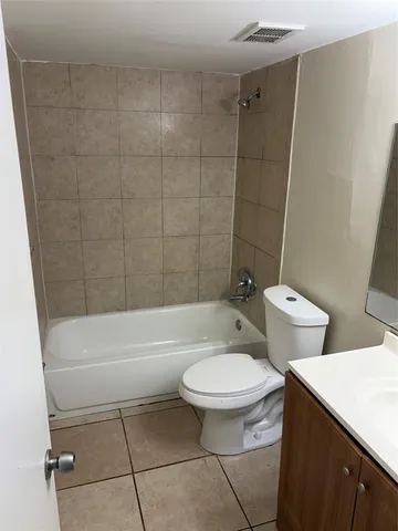 a bathroom with a toilet a sink and bathtub