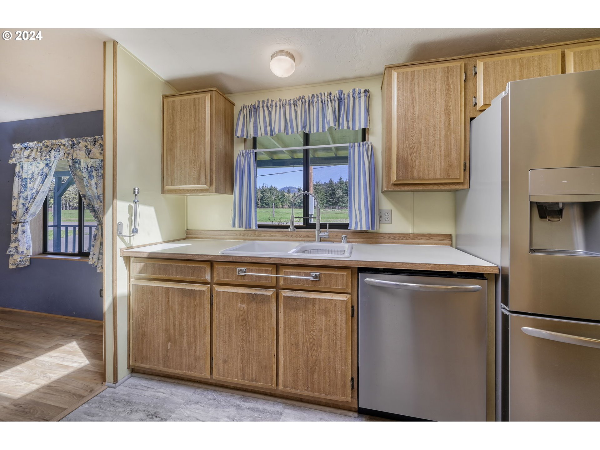 78414 Sears Road Cottage Grove, OR 97424 - Photo 15 of 44 a kitchen with stainless steel appliances granite countertop a refrigerator and a sink