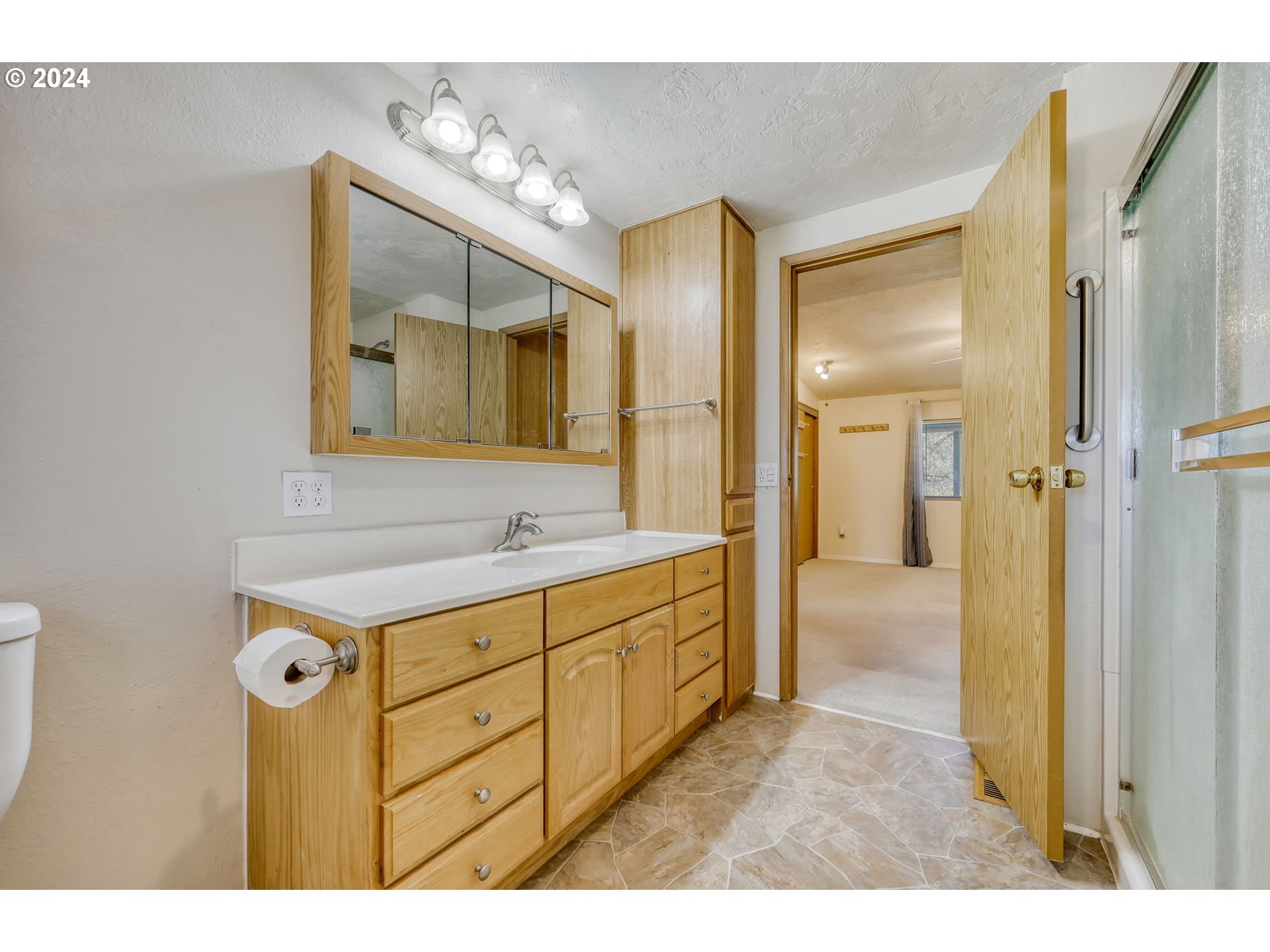 78414 Sears Road Cottage Grove, OR 97424 - Photo 22 of 44 a bathroom with a sink a mirror and a shower