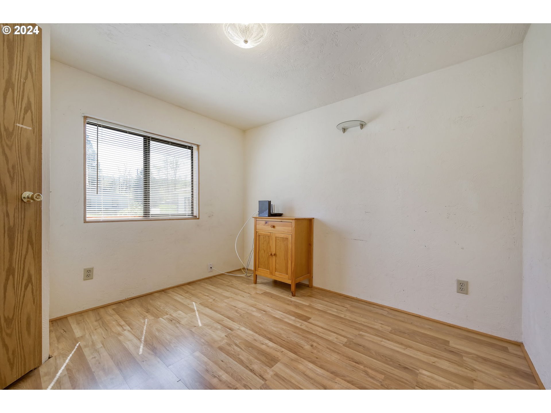 78414 Sears Road Cottage Grove, OR 97424 - Photo 26 of 44 an empty room with wooden floor and windows