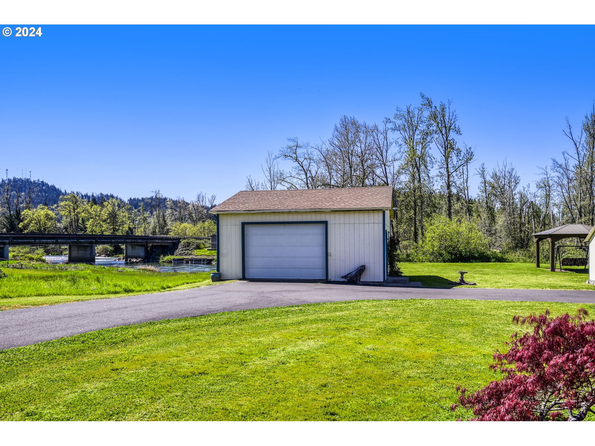 78414 Sears Road Cottage Grove, OR 97424 - Photo 5 of 44 a view of a yard with a house in the background
