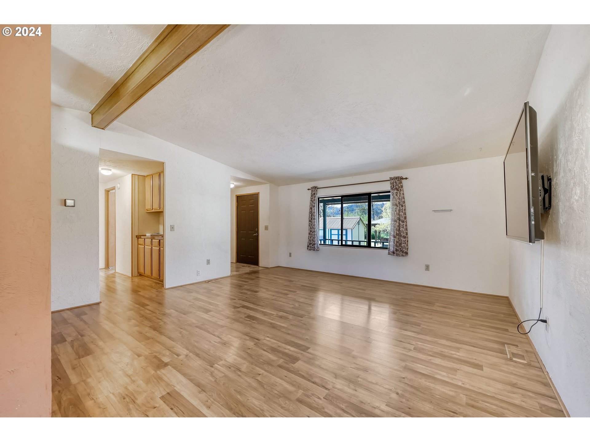 78414 Sears Road Cottage Grove, OR 97424 - Photo 9 of 44 a view of an empty room with wooden floor and a window