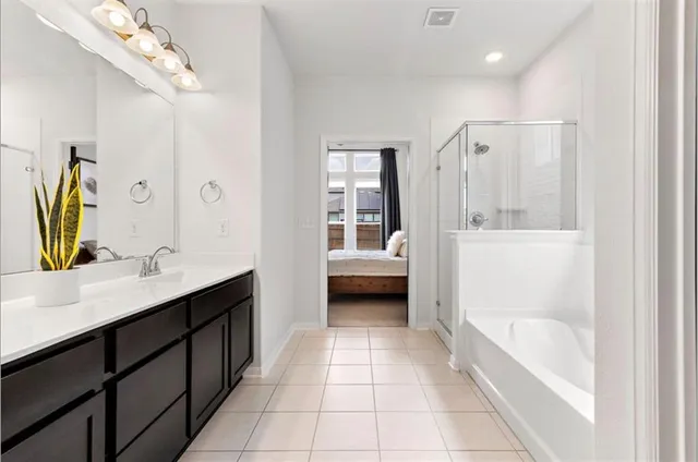 a bathroom with a tub a sink and mirrors
