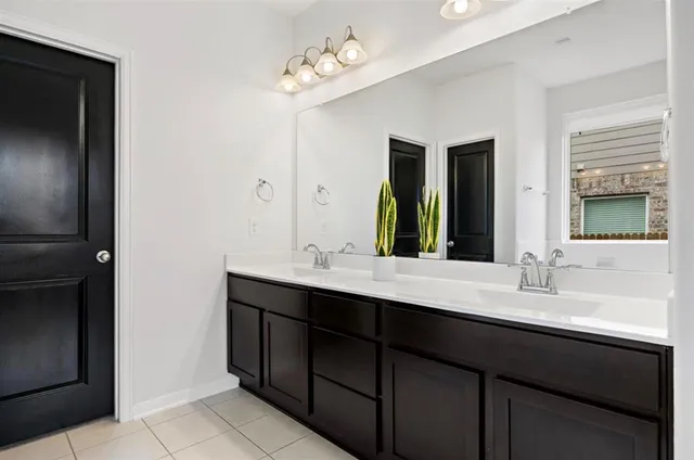 a bathroom with a sink double vanity and a mirror