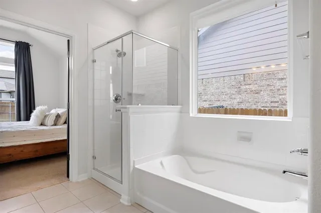 a spacious bathroom with a bathtub and a shower
