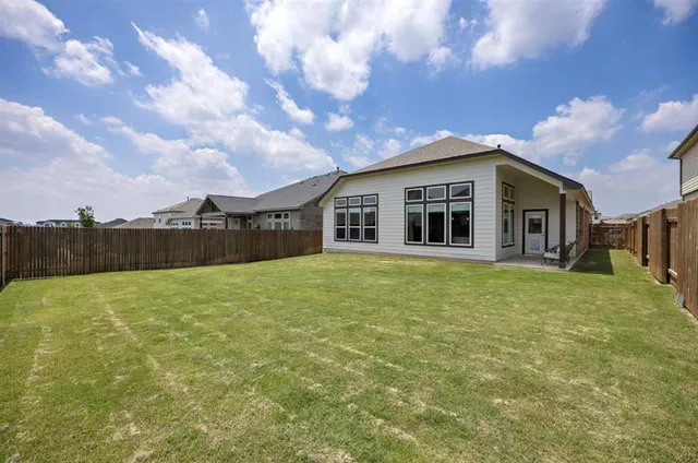 a view of a house with a backyard