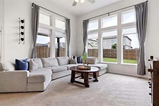 a living room with furniture and a large window