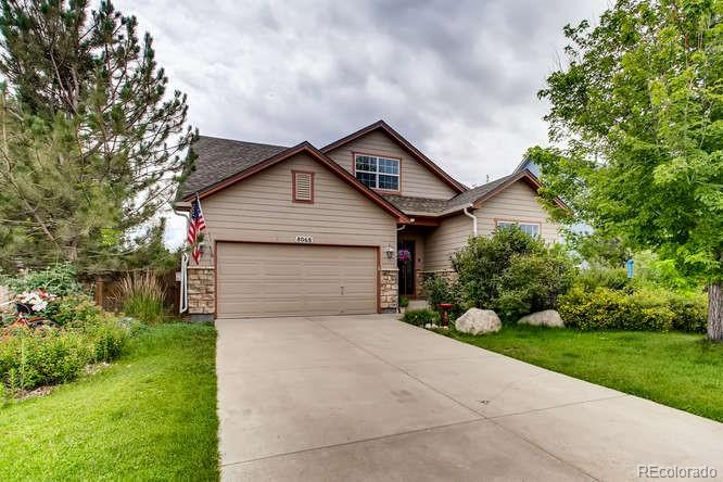 8068 Raspberry Drive Frederick, CO 80504 - Photo 1 of 26 a front view of a house with a yard and garage