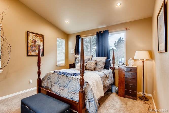 8068 Raspberry Drive Frederick, CO 80504 - Photo 13 of 26 a bedroom with a bed and wooden floor