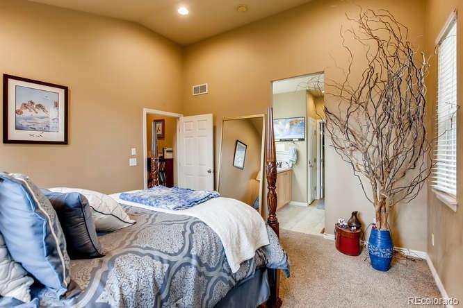 8068 Raspberry Drive Frederick, CO 80504 - Photo 15 of 26 a bedroom with a bed and a couch