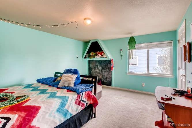 8068 Raspberry Drive Frederick, CO 80504 - Photo 20 of 26 a bed room with furniture and a window