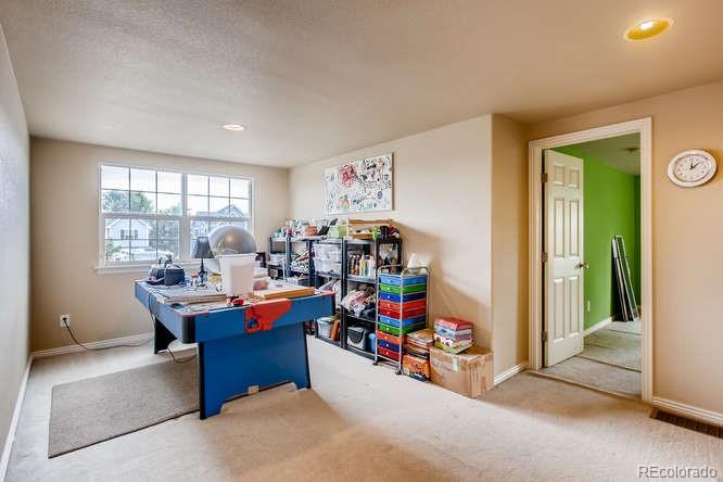 8068 Raspberry Drive Frederick, CO 80504 - Photo 22 of 26 a view of a workspace with furniture and a window