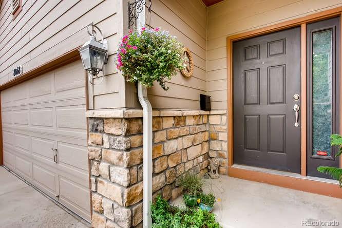 8068 Raspberry Drive Frederick, CO 80504 - Photo 3 of 26 a potted plant sitting in front of a door