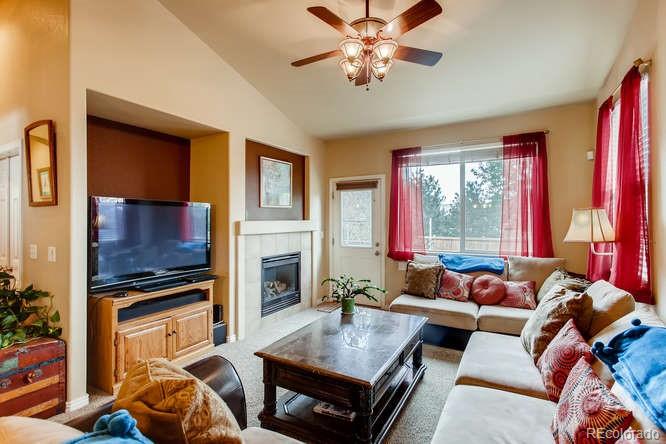 8068 Raspberry Drive Frederick, CO 80504 - Photo 4 of 26 a living room with furniture and a fireplace