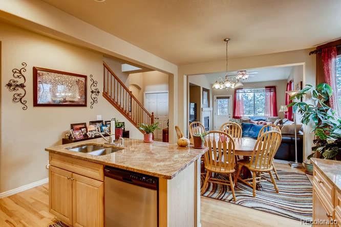 8068 Raspberry Drive Frederick, CO 80504 - Photo 10 of 26 a view of a dining room with furniture and a chandelier