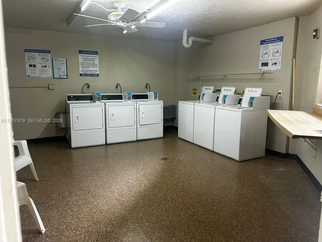 a utility room with cabinets washer and dryer
