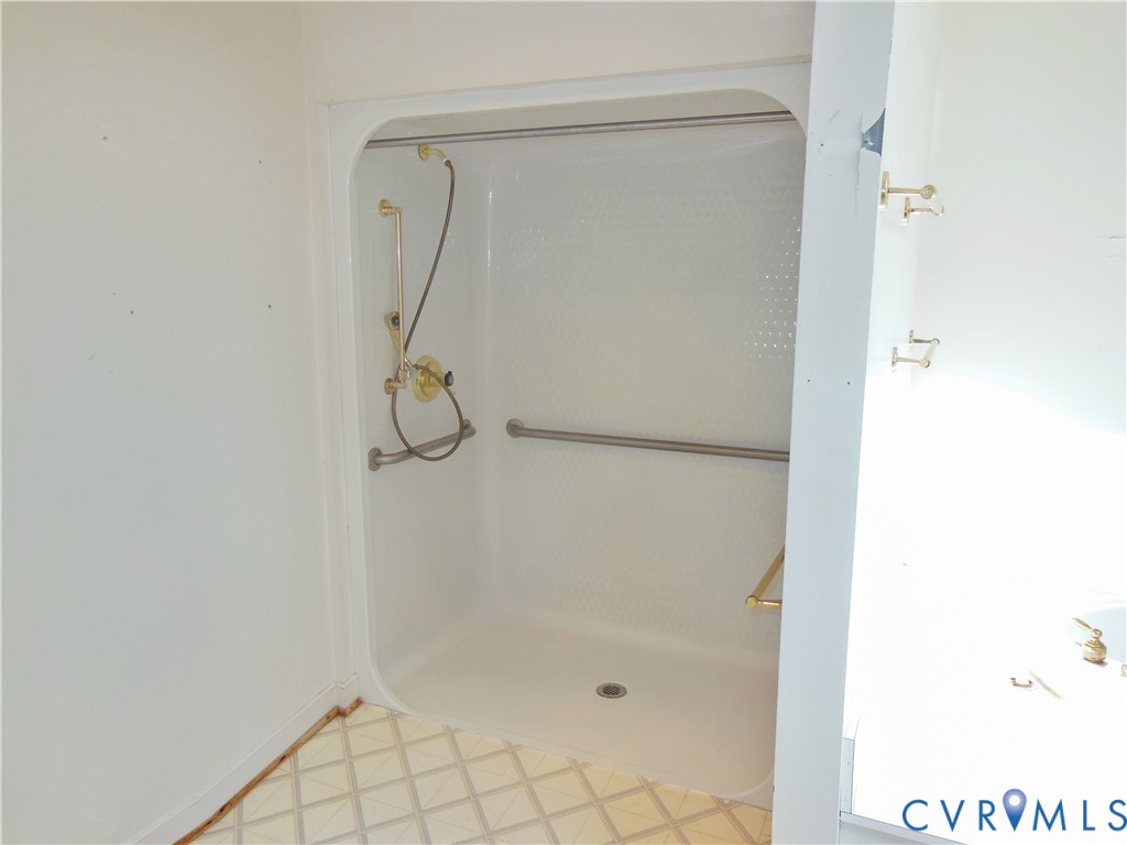8218 Overbury Road Richmond, VA 23227 - Photo 18 of 37 a bathroom with a glass shower door
