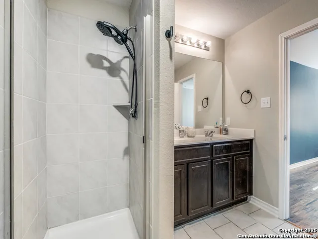 a bathroom with a sink vanity and a mirror