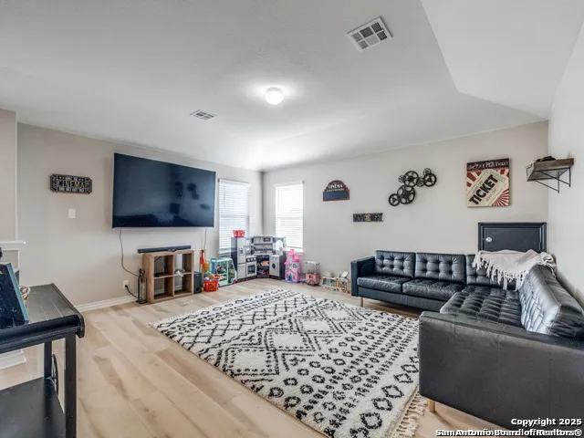 a bedroom with furniture and a flat screen tv