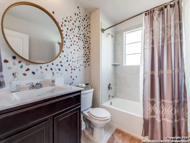 a bathroom with a granite countertop sink mirror toilet and bathtub