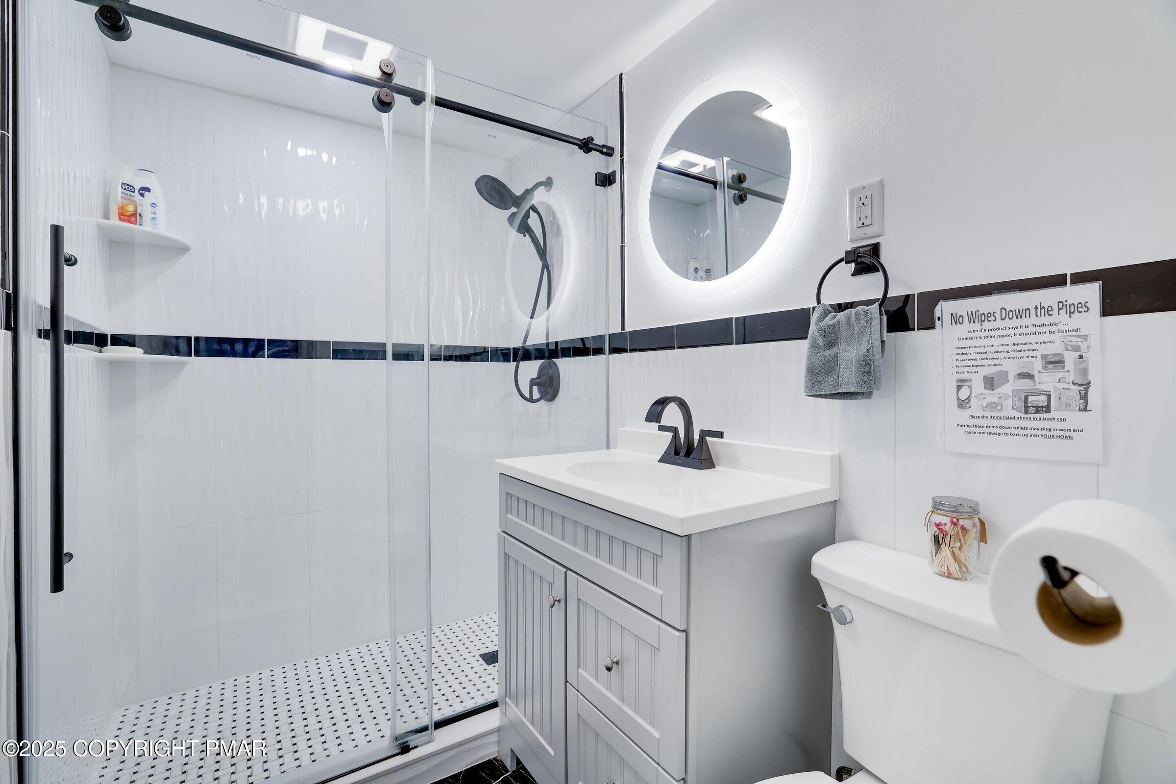 5814 Decker Road Bushkill, PA 18324 - Photo 17 of 29 a bathroom with a sink vanity mirror and shower