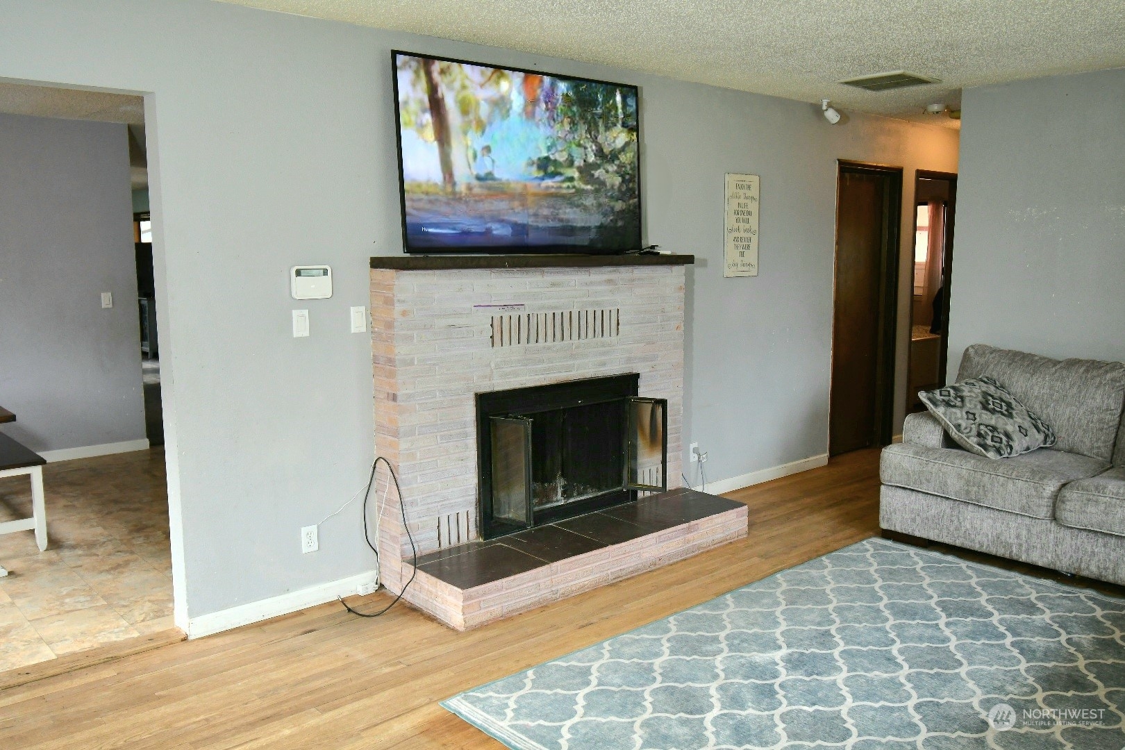 813 Southwest 19th Street Chehalis, WA 98532 - Photo 10 of 17 a living room with furniture a fireplace and wall paintings