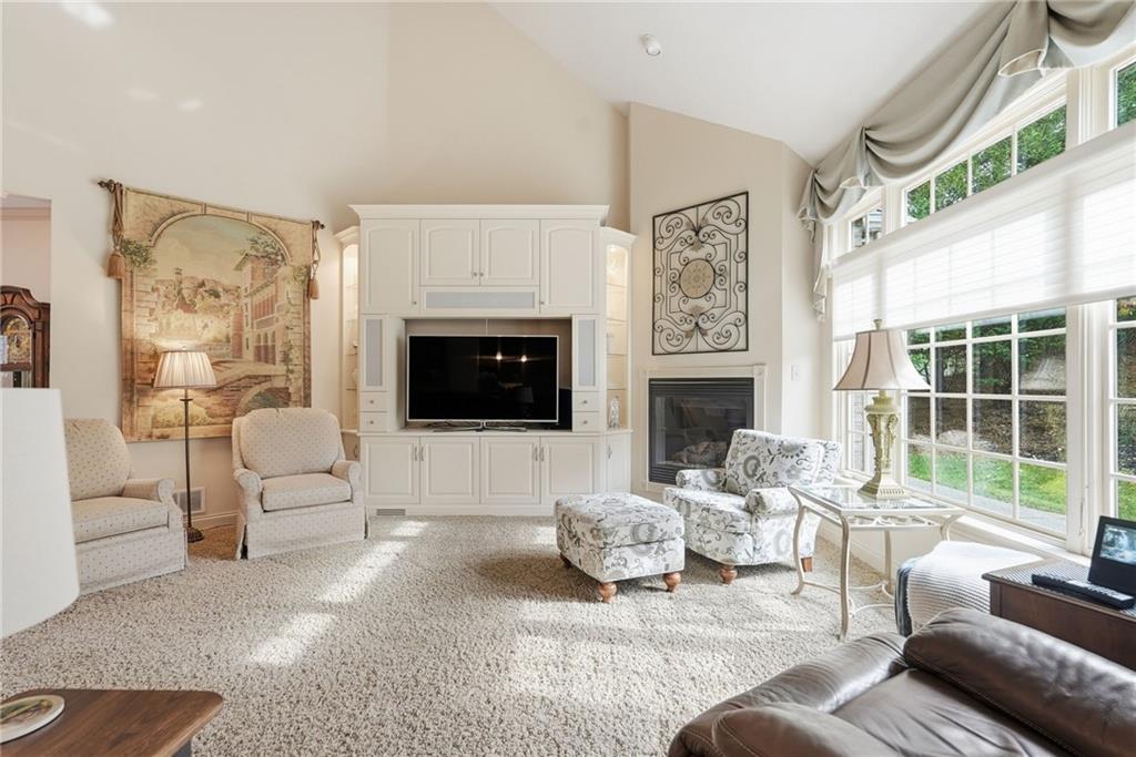 174 Springdale Road Venetia, PA 15367 - Photo 8 of 45 a living room with furniture a flat screen tv and a fireplace