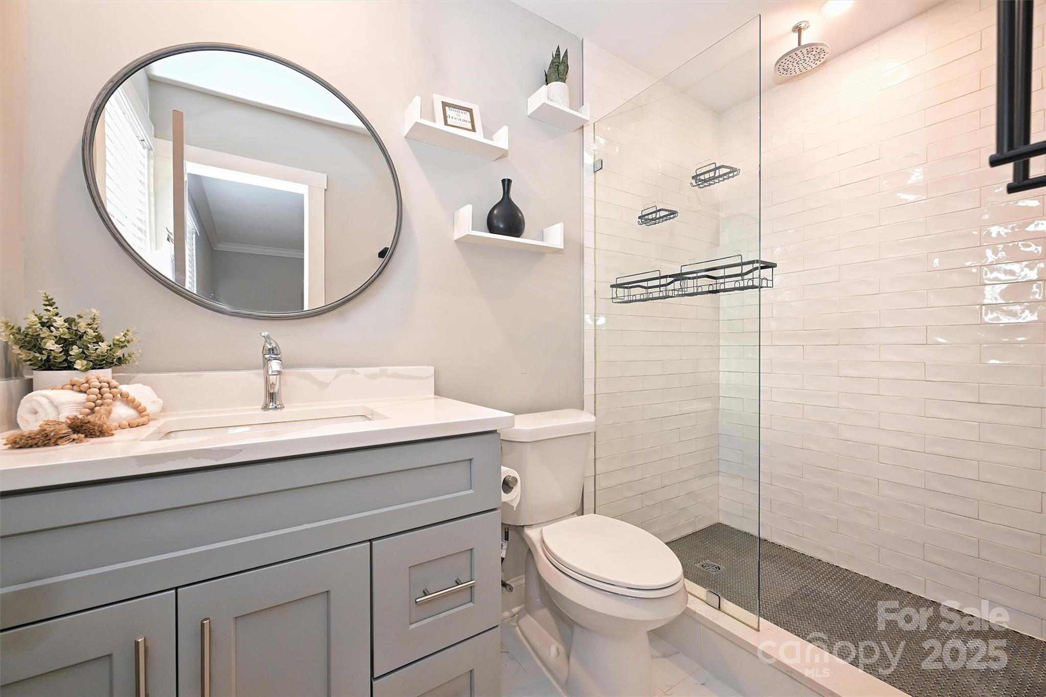 532 Scaleybark Road Charlotte, NC 28209 - Photo 14 of 29 a bathroom with a sink a toilet and a mirror