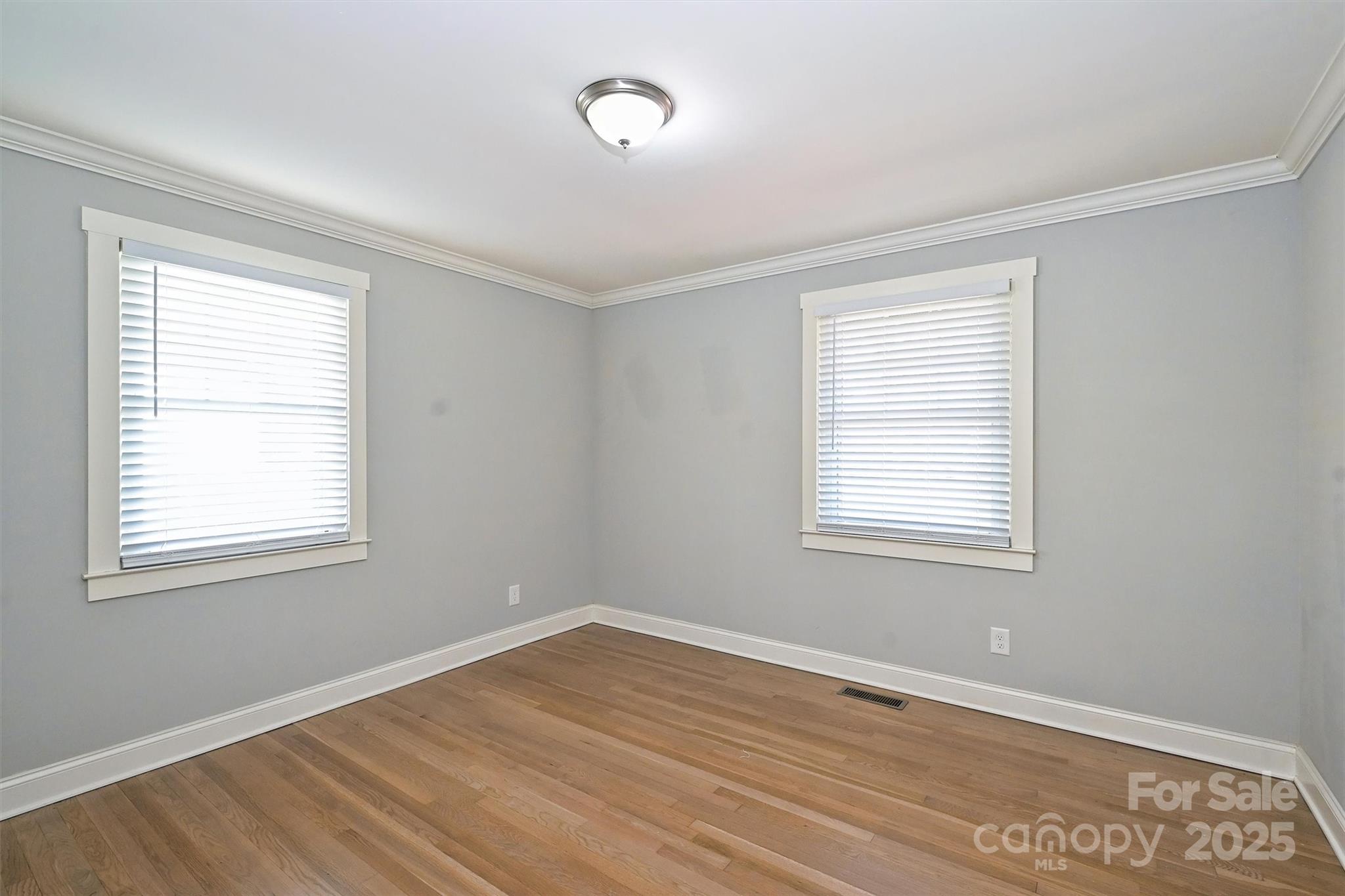 532 Scaleybark Road Charlotte, NC 28209 - Photo 16 of 29 a view of an empty room with wooden floor and a window
