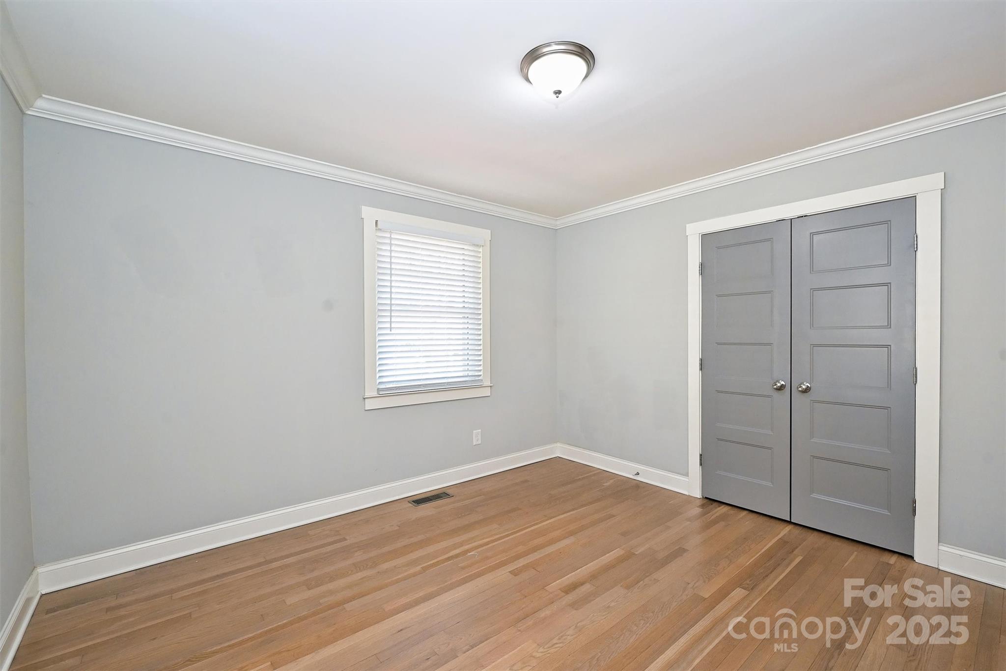 532 Scaleybark Road Charlotte, NC 28209 - Photo 17 of 29 an empty room with wooden floor closet and windows