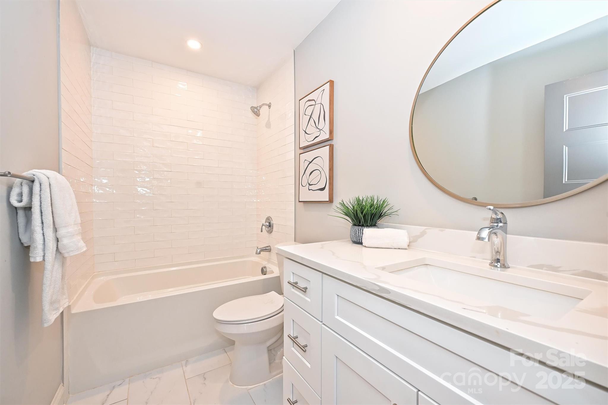 532 Scaleybark Road Charlotte, NC 28209 - Photo 18 of 29 a bathroom with a granite countertop sink a toilet and bathtub