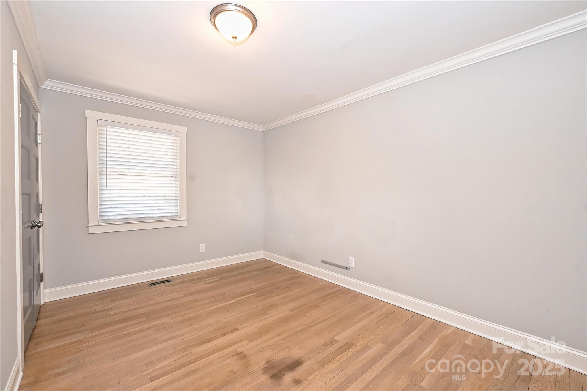 532 Scaleybark Road Charlotte, NC 28209 - Photo 19 of 29 an empty room with wooden floor and windows
