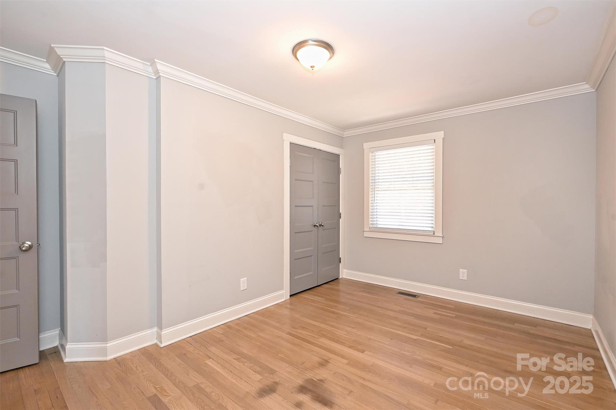 532 Scaleybark Road Charlotte, NC 28209 - Photo 20 of 29 a view of an empty room with wooden floor and a window