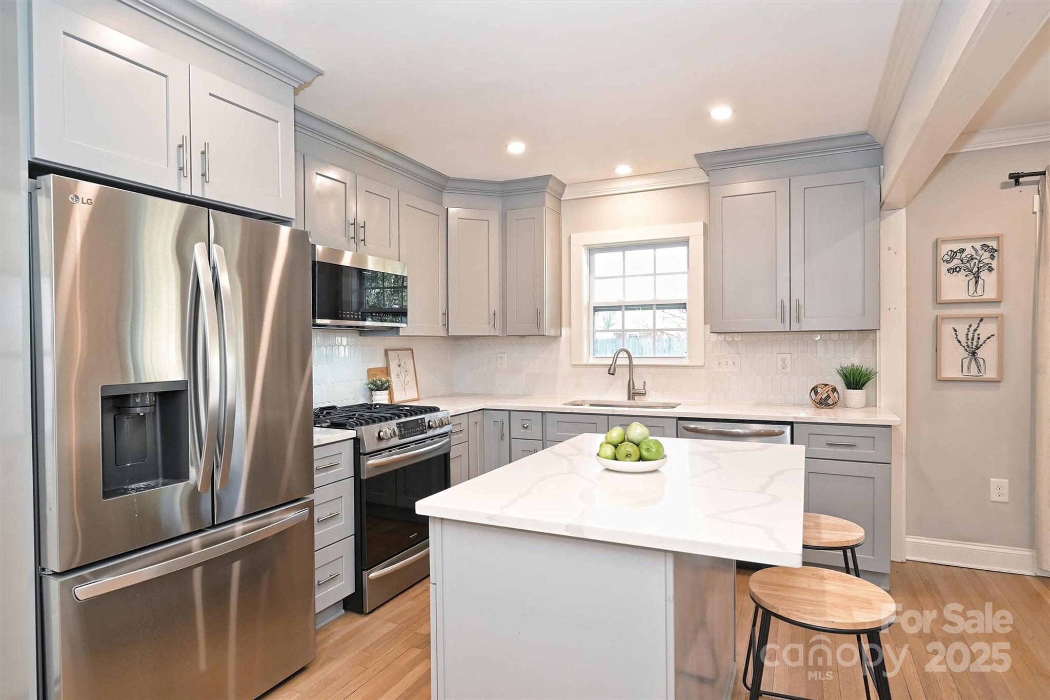 532 Scaleybark Road Charlotte, NC 28209 - Photo 4 of 29 a kitchen with stainless steel appliances granite countertop a refrigerator a stove a sink and a microwave