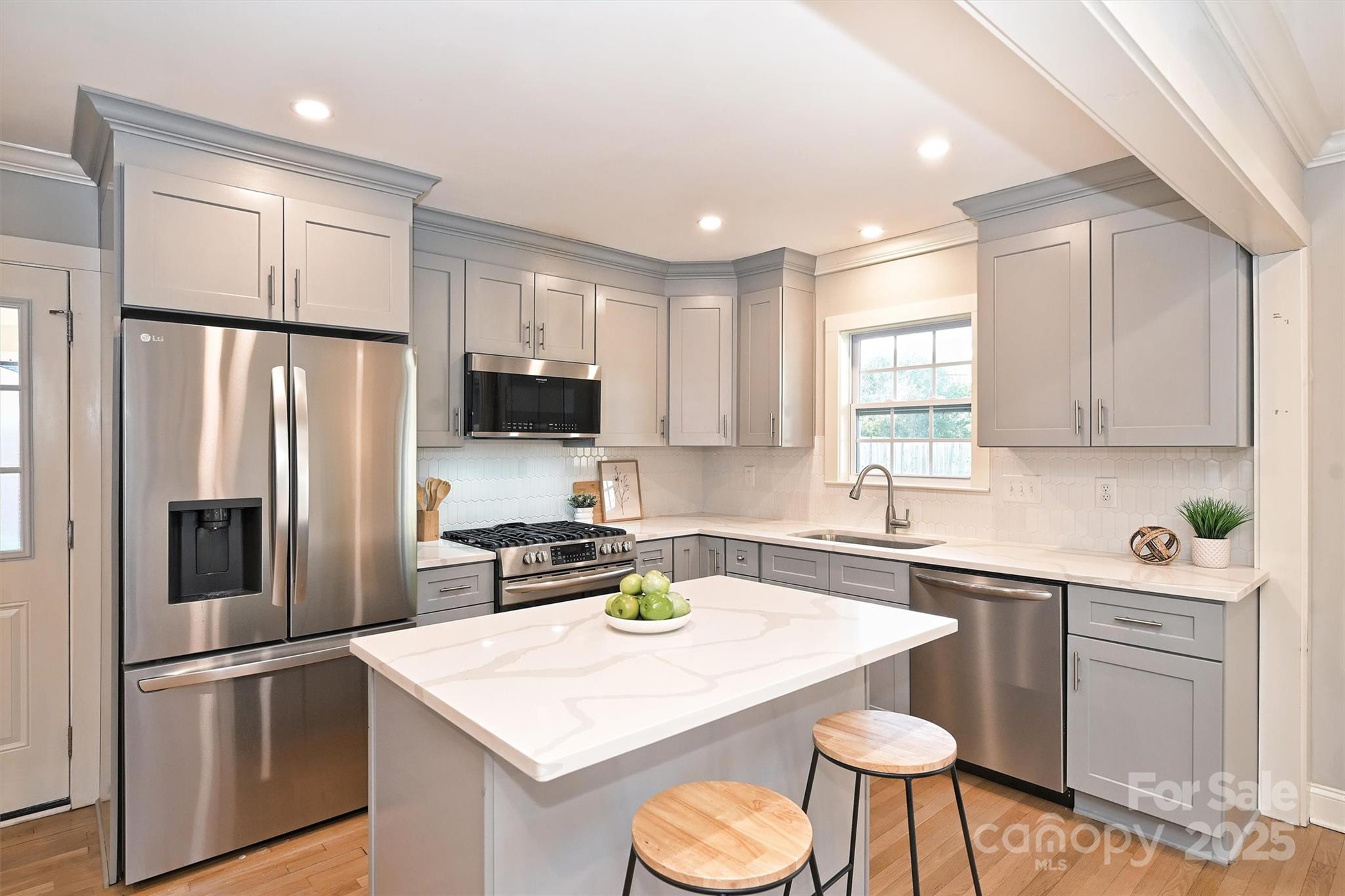 532 Scaleybark Road Charlotte, NC 28209 - Photo 5 of 29 a kitchen with stainless steel appliances a sink a stove a refrigerator cabinets and a dining table