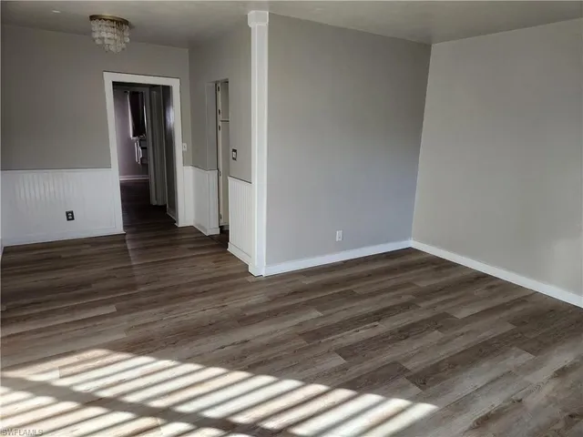 a view of a room with wooden floor