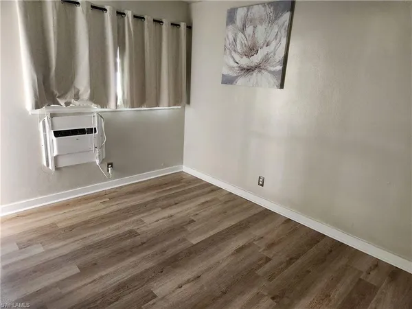 a view of wooden floor and chair in a room