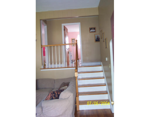 19 Chamberlain Road Chelmsford, MA 01824 - Photo 2 of 9 a view of a hallway with two windows and a white door