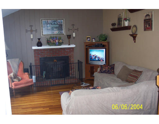 19 Chamberlain Road Chelmsford, MA 01824 - Photo 6 of 9 a living room with furniture and a fireplace