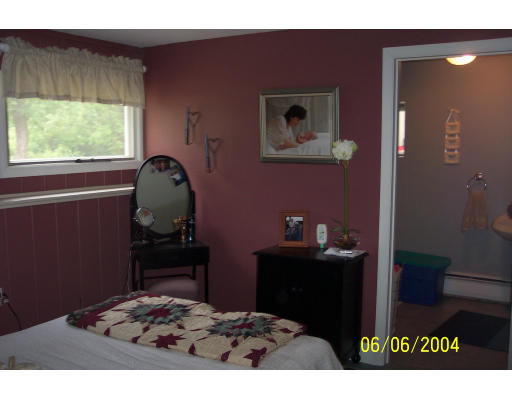 19 Chamberlain Road Chelmsford, MA 01824 - Photo 7 of 9 a bedroom with a bed and a table